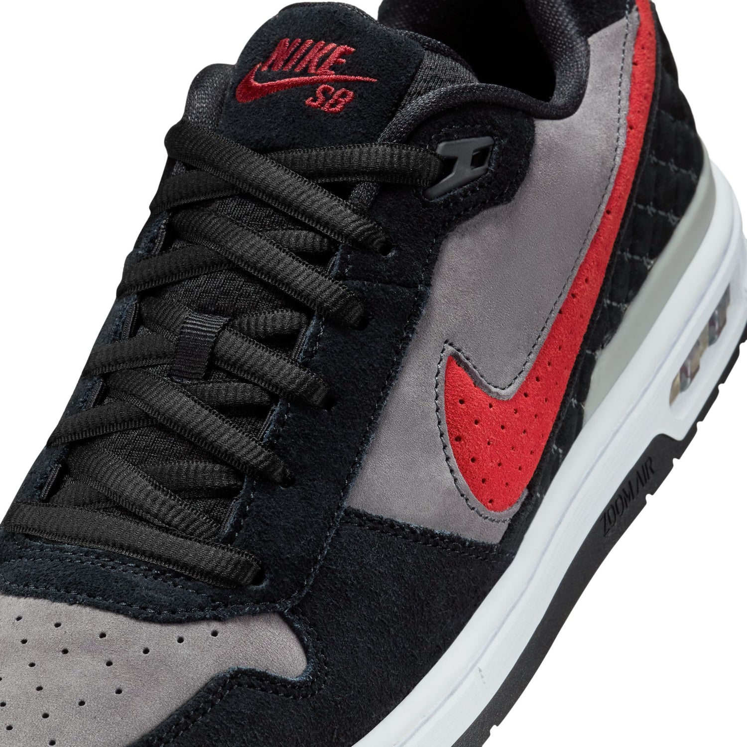 Black, gray, and red Nike SB sneaker on a white background