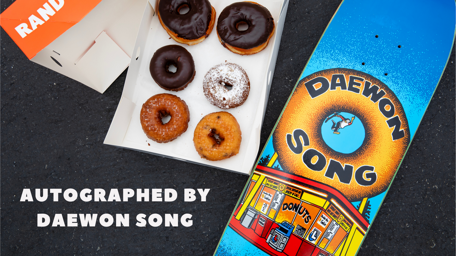 Skateboard with 'Daewon Song' branding next to a box of donuts with 'Randy's' branding.