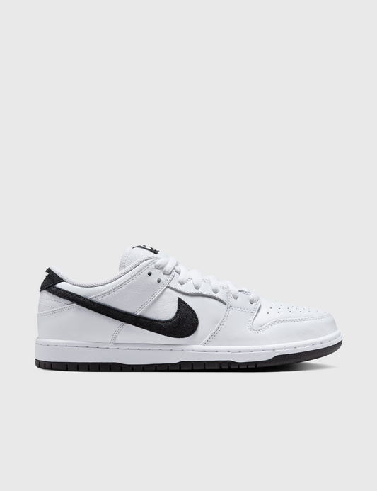 Nike SB Dunk Low Pro skate shoes with white uppers, black detailing, and a white midsole.
